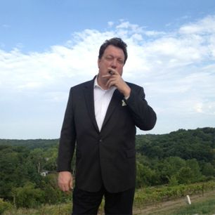 Gillis C. Leonard outside smoking cigar